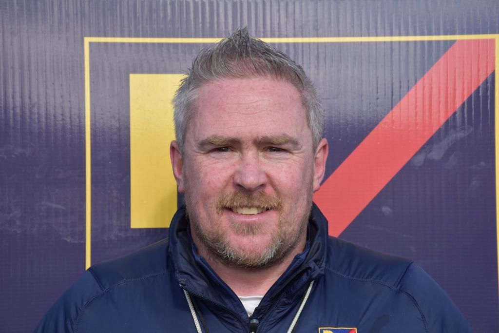 Richie in Rosemount Mulvey Elite jacket. He has grey short back and side and a beard.